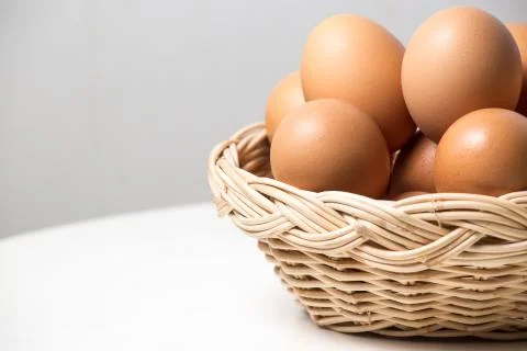Eggs in basket Stock Photos