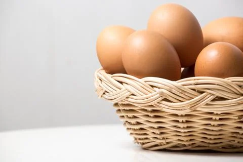 Eggs in basket Stock Photos