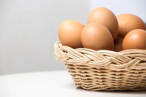 Eggs in basket Stock Photos