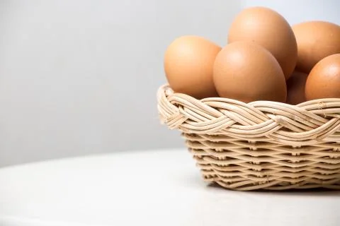Eggs in basket Stock Photos