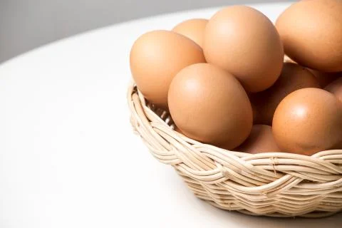 Eggs in basket Stock Photos
