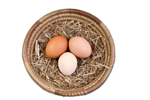 Eggs in Basket with Straw Stock Photos