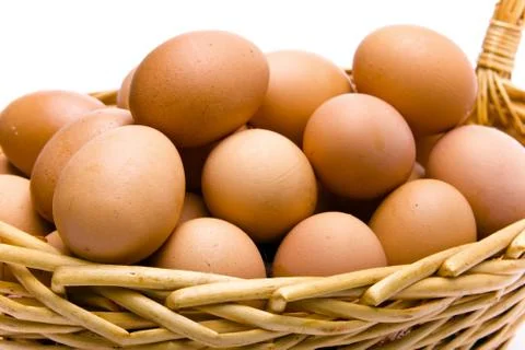 Eggs in basket on white background Stock Photos