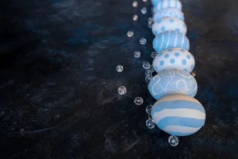Eggs with beads on dark background Stock Photos