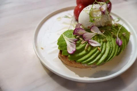 Eggs Benedict with avocado Stock Photos