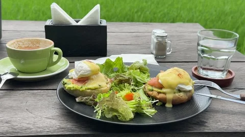 Eggs benedict with salmon for breakfast with a nice rice field view. Stock Footage 270510225