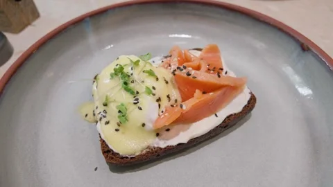 Eggs benedict with smoked salmon on rye toast Stock Footage 346289852