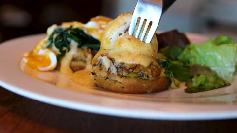 Eggs Benedict Toast with poached egg and bacon close up. Cutting poached egg Stock Footage 295060824