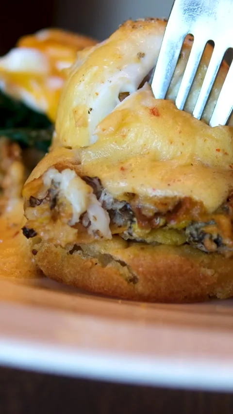 Eggs Benedict Toast with poached egg and bacon close up. Cutting poached egg Stock Footage 295965227