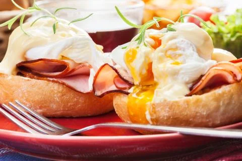 Eggs benedict on toasted muffins with ham and sauce Stock Photos