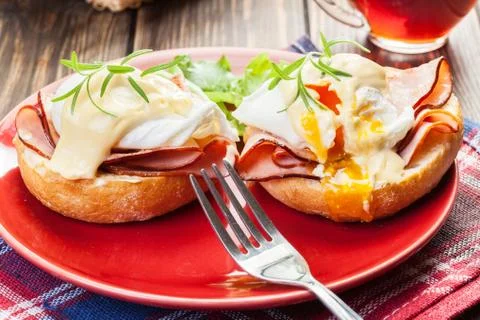 Eggs Benedict on toasted muffins with ham and sauce Stock Photos