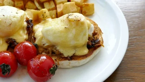Eggs Benedict with tomato Stock Footage 81402776