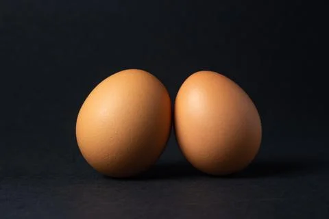 Eggs on a black background.  Stock Photos