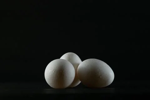 Eggs on black background Stock Photos
