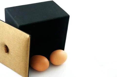Eggs in black box Stock Photos