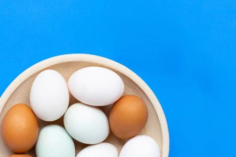 Eggs on blue background. Stock Photos