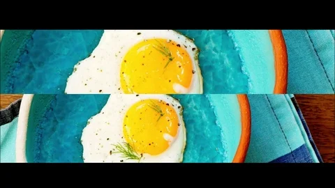 Eggs in a blue seramic pan. Video stock 104359741