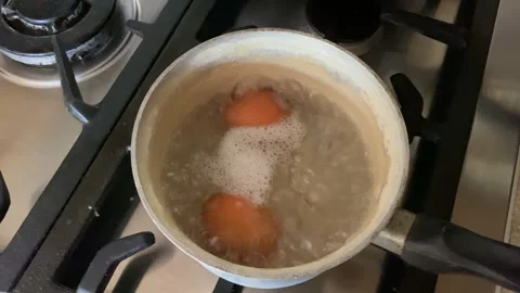 Eggs boiling in a pan Stock Footage 188045754