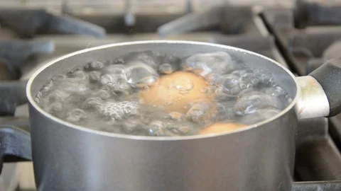 Eggs Boiling in Pan - low close shot Stock Footage 111095578