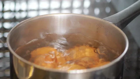 Eggs boiling in the pot in 4k slow motion 60fps Stock Footage 142312384