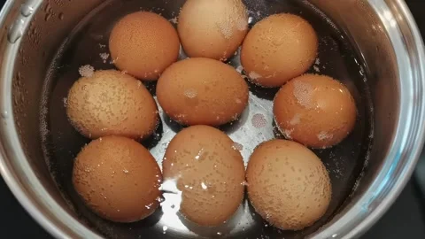 Eggs boiling in water, close up. Stock Footage 163865361