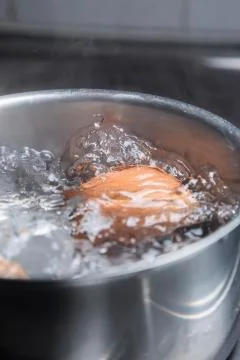Eggs in boiling water 스톡 사진