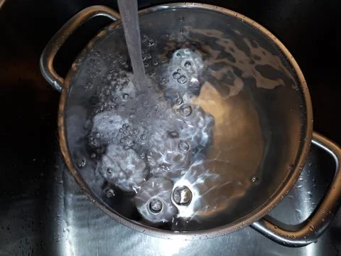 Eggs boiling in water Stock Photos