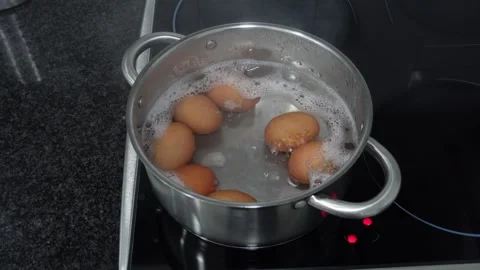Eggs boiling in a wide pot Stock Footage 283865643
