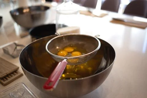 Eggs in a bowl on the kitchen table for making a pie at a culinary master class Stock Photos