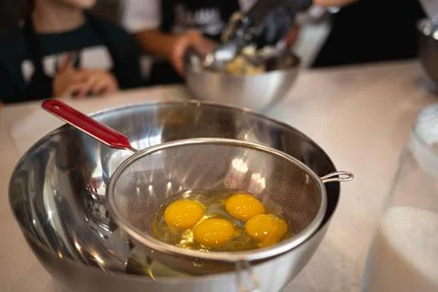 Eggs in a bowl on the kitchen table for making a pie at a culinary master class 스톡 사진