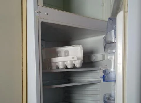 Eggs box in empty fridge 写真素材