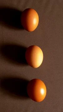 Eggs on the brown background Stock Photos