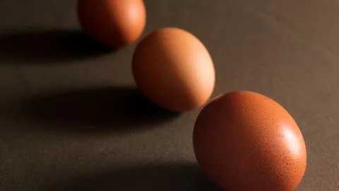 Eggs on the brown background Stock Photos