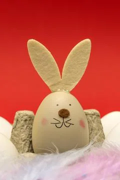 Eggs with bunny ears and a muzzle in an environmentally friendly paper tray,  Stock Photos