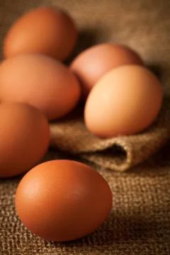 Eggs on burlap Stock Photos