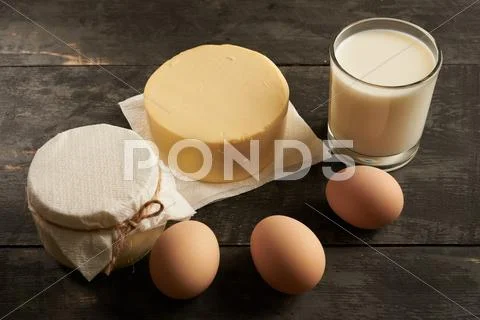 Eggs, butter, milk, sour cream on a table close-up Stock Photos