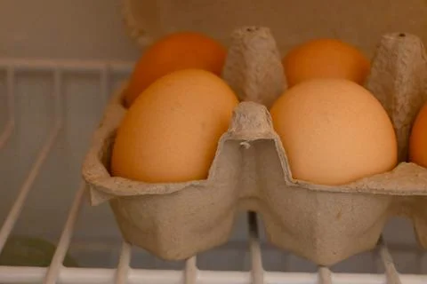 Eggs in a carton inside a refrigerator Stockfoto's