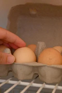 Eggs in a carton inside a refrigerator Фото