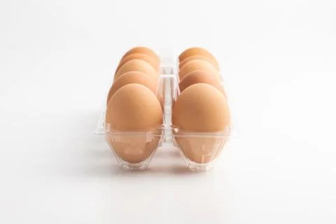 Eggs in a clear box on the white background Stock Photos
