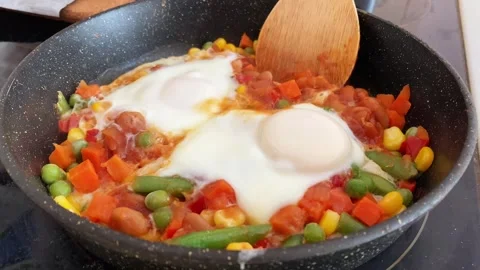 Eggs cooked to perfection with fresh vegetables. Ideal for breakfast Stock Footage 318780305