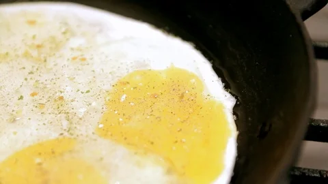 Eggs cooking in a cast iron pan Stock Footage 101194919