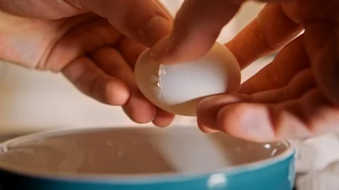 Eggs cracking in bowl slow motion Stock Footage 126058266