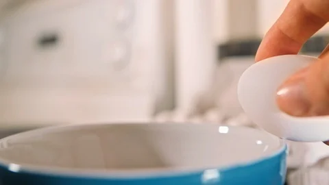 Eggs cracking in bowl slow motion Stock Footage 126058611