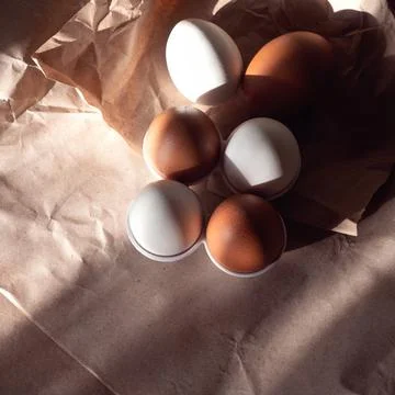 Eggs on crumpled paper. Stock Photos