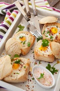 Eggs in crunchy bread rolls Stock Photos