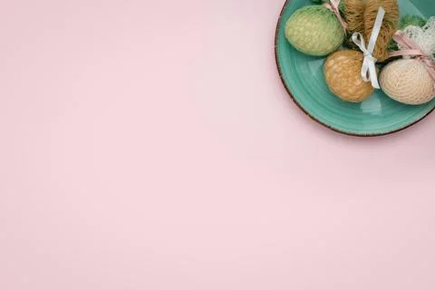Eggs decorated with ribbons on a plate. Easter background Stock Photos