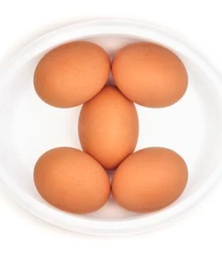 Eggs in a dish (isolated) Stock Photos
