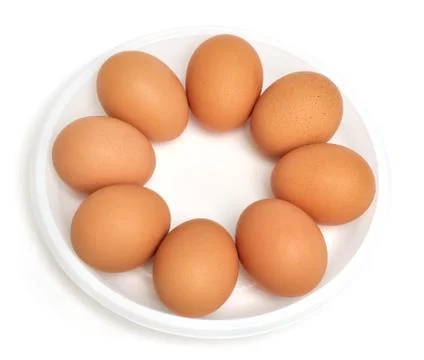 Eggs in a dish (isolated) Stock Photos