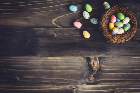 Eggs easter in the nest on wood background with copyspace. Stock Photos