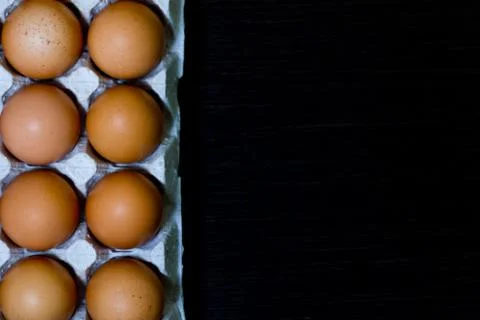 Eggs egg carton box copyspace food box dark wooden board top view top Stock Photos